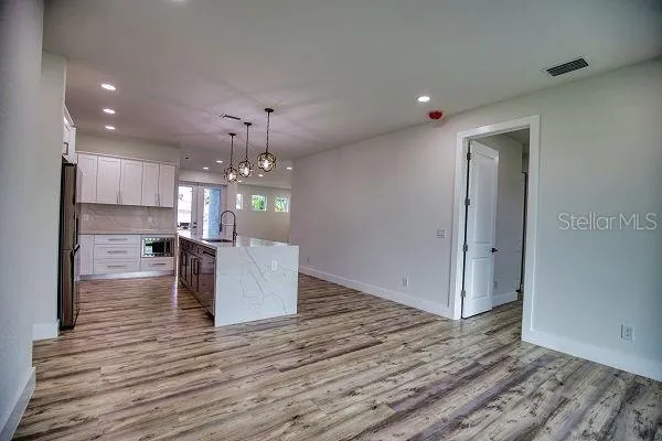 a kitchen with stainless steel appliances granite countertop a refrigerator sink and stove