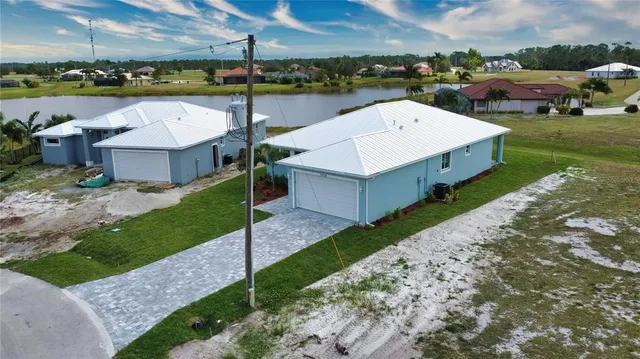 an aerial view of a residential houses with outdoor space