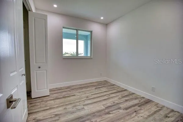 a view of a room with an empty space and a ceiling fan