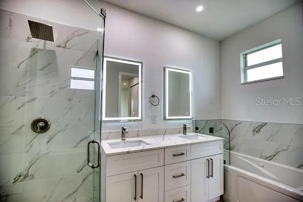 an aerial view of a house with a yard and lake view