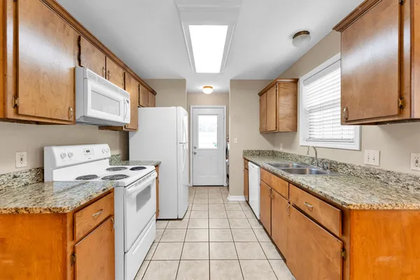 a kitchen with a stove a refrigerator and a sink