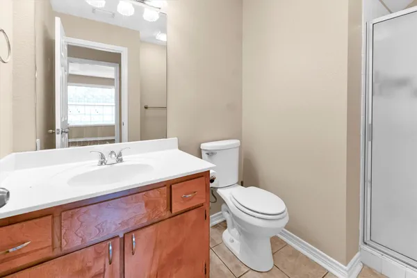 a bathroom with a glass shower door