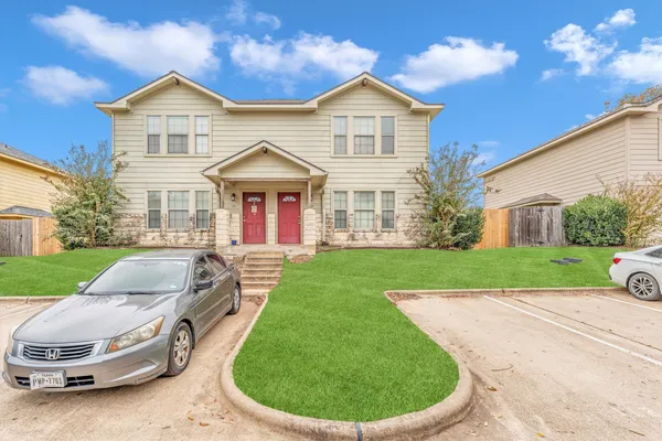 a view of a house with a swimming pool and a yard
