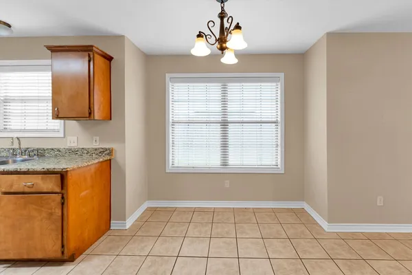 a open kitchen with stainless steel appliances granite countertop a stove and a sink with granite countertops