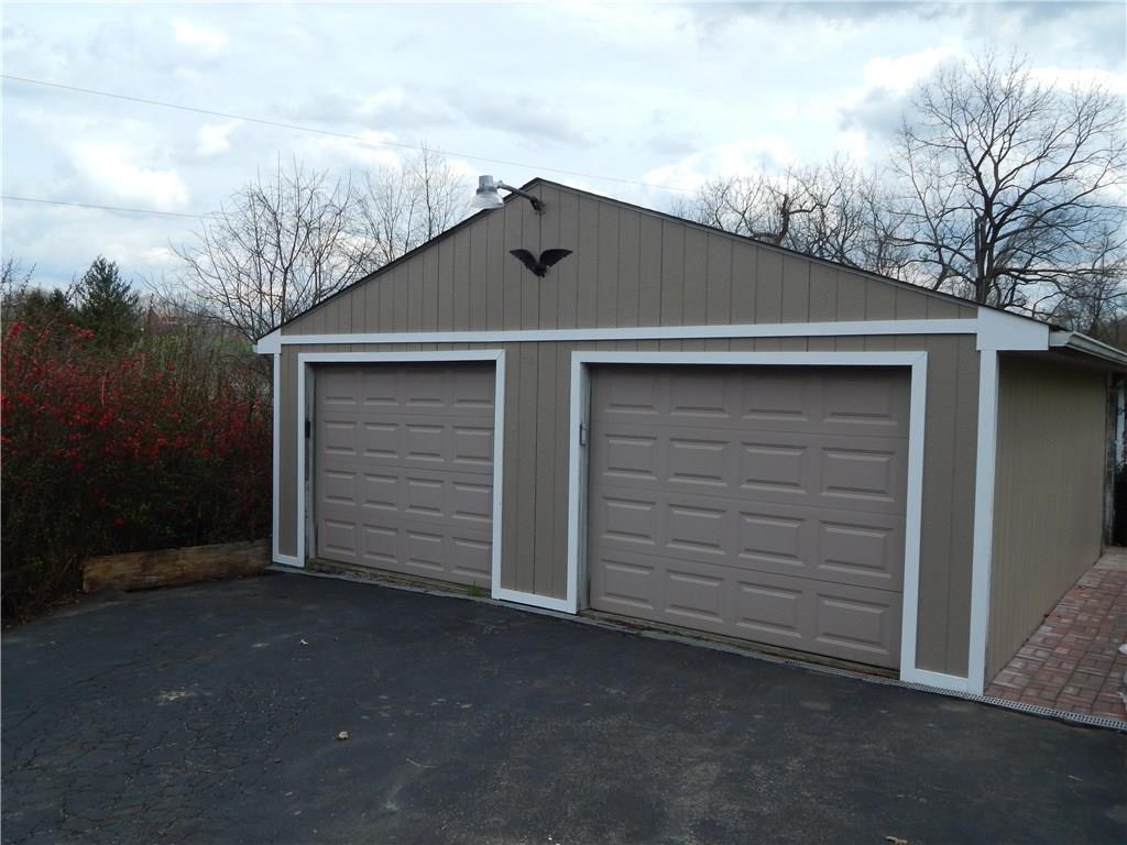 478 Myers Road Eighty Four, PA 15330 - Photo 3 of 18 Large 4-car Garage plus additional parking on the paved driveway. Back half of garage currently used as a workshop, but could easily be converted back to be used to store 4 cars.