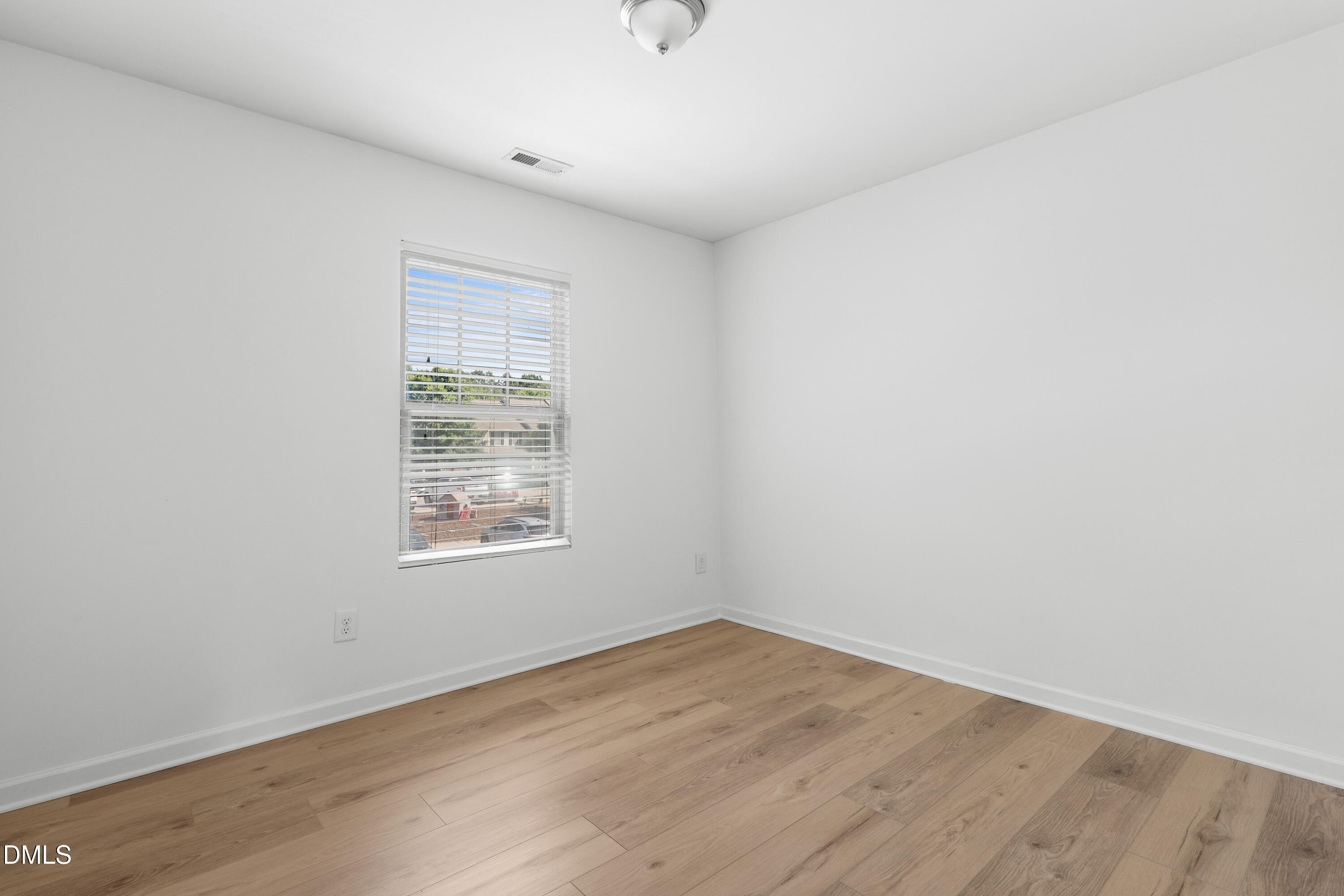 4400 Hillsgrove Road Wake Forest, NC 27587 - Photo 30 of 49 a view of an empty room with wooden floor and a window