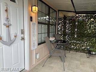 5322 Treetops Drive, Unit I Naples, FL 34113 - Photo 16 of 18 a view of entryway with wooden door