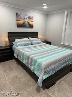 a bedroom with a bed and painting on the wall