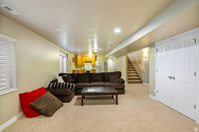 557 South 1470th Street East Springville, UT 84663 - Photo 27 of 46 Living room with stairway and light carpet