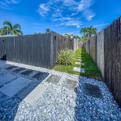 a view of a backyard with wooden fence