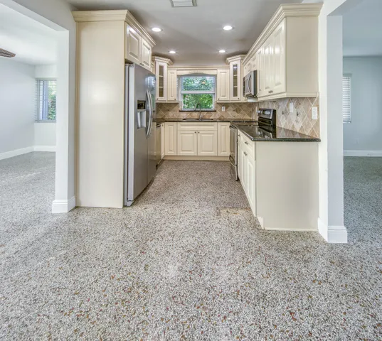 a kitchen with refrigerator and cabinets