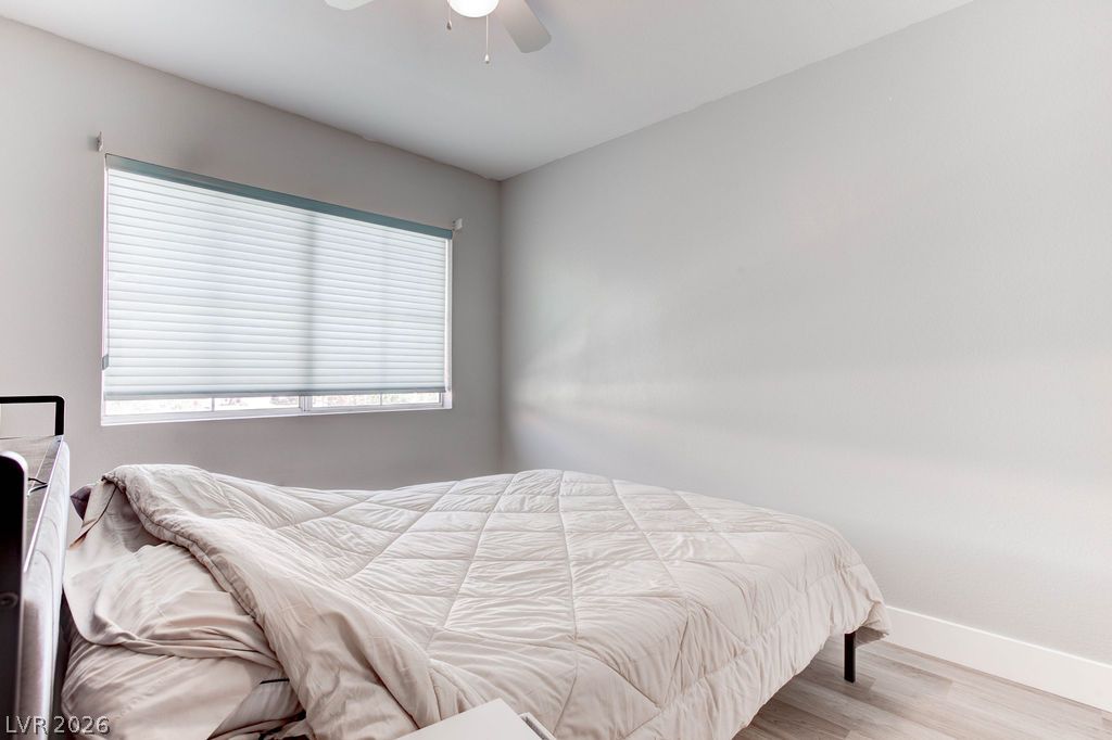 1 Rising Sun Court Henderson, NV 89074 - Photo 27 of 47 Natural light filters through the window into this comfortable bedroom with a ceiling fan.