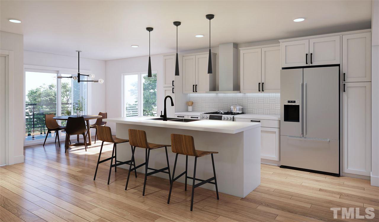 1027 Gregg Street Raleigh, NC 27601 - Photo 2 of 29 a kitchen with stainless steel appliances granite countertop a table chairs wooden floors a large window and white cabinets