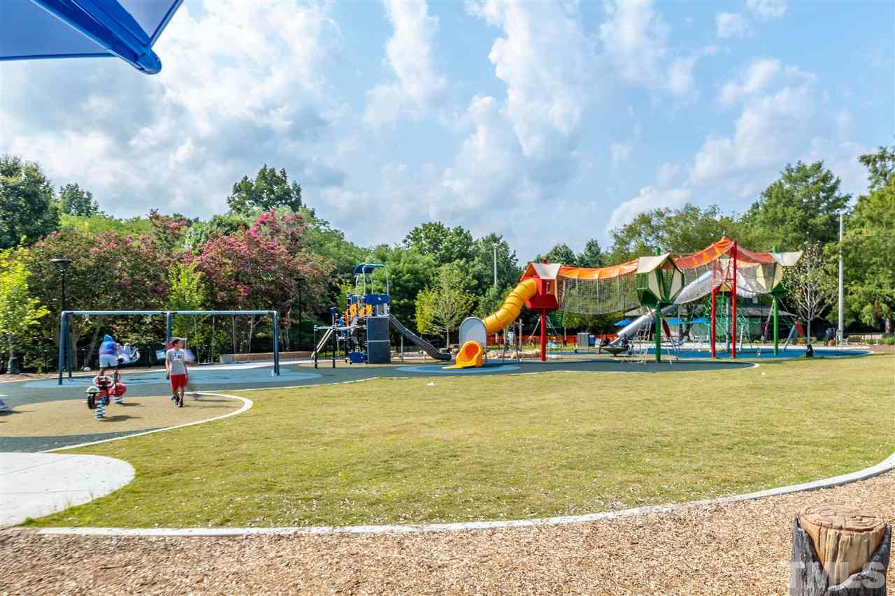 1027 Gregg Street Raleigh, NC 27601 - Photo 15 of 29 a view of a swimming pool with lawn chairs and a yard