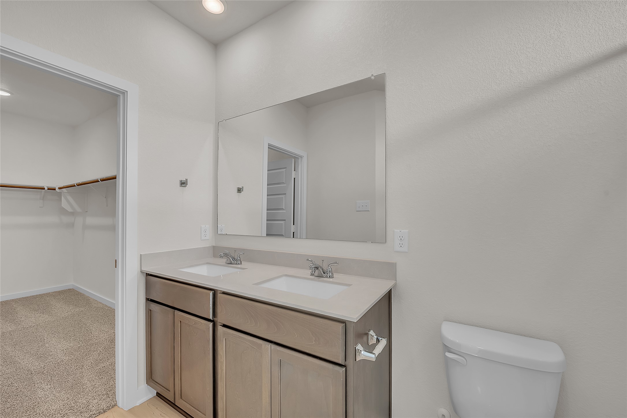 308 Boatright Boulevard Jarrell, TX 76537 - Photo 13 of 31 Bathroom with double vanity, light carpet, and a spacious closet