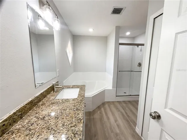 a bathroom with a tub and shower