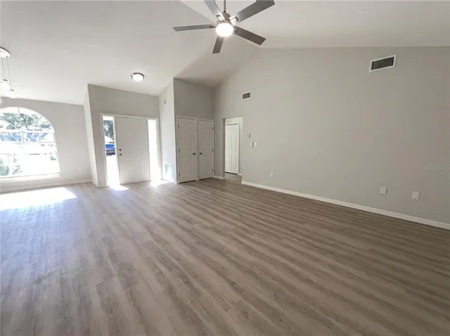 wooden floor in an empty room with a window