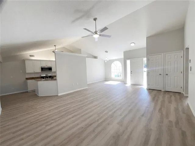 a view of a kitchen with a sink and a refrigerator