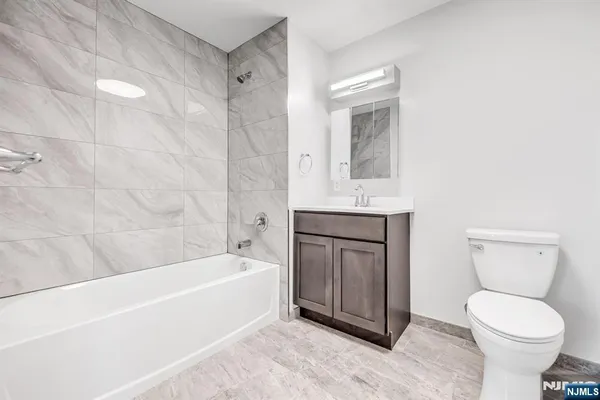 a bathroom with a toilet sink and bathtub