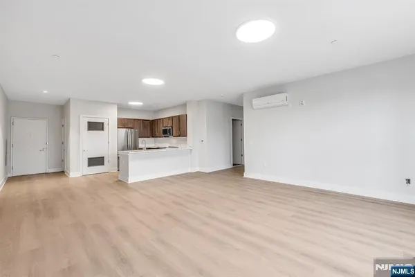 a view of a kitchen with a sink and a refrigerator