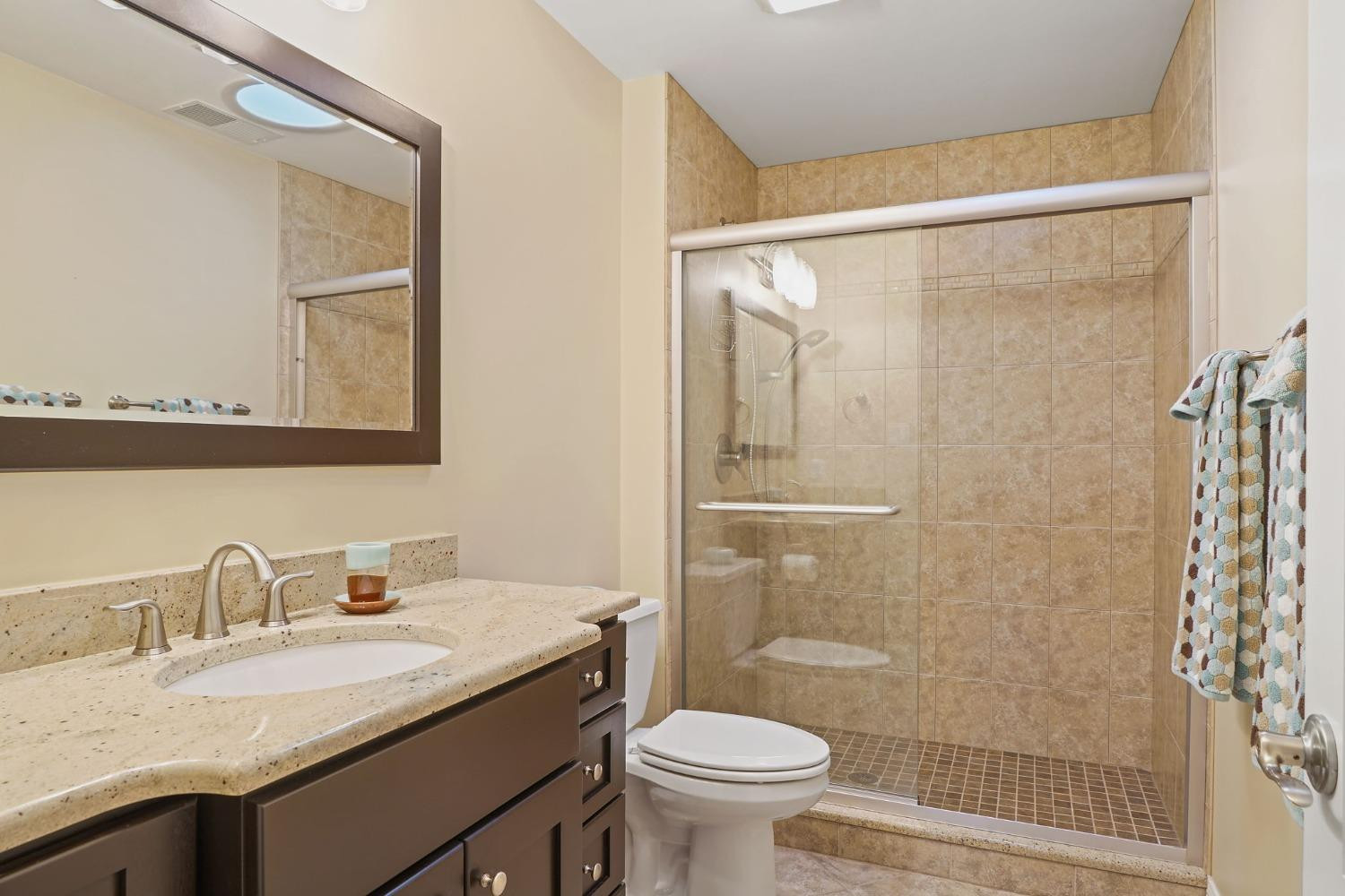 1435 Ridge Road Munster, IN 46321 - Photo 56 of 63 a bathroom with a granite countertop sink toilet and shower