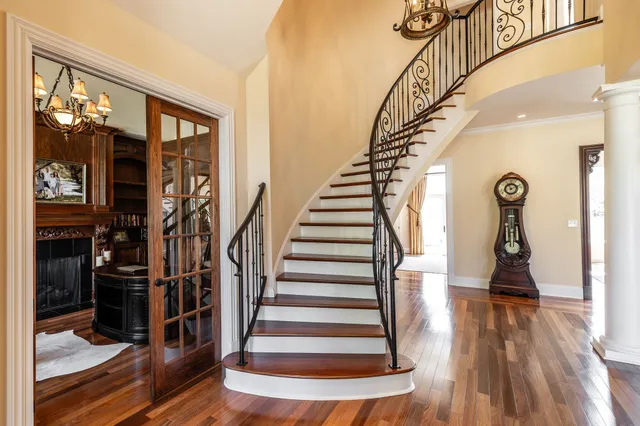 a view of entryway and hall with wooden floor