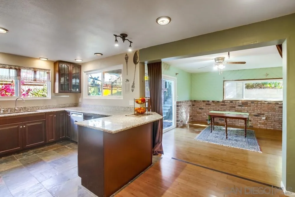 9337 Goyette Place Santee, CA 92071 - Photo 16 of 20 a kitchen with granite countertop a sink and counter top space