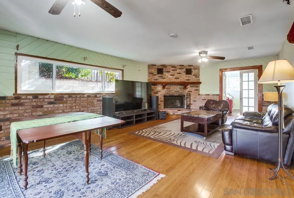 9337 Goyette Place Santee, CA 92071 - Photo 18 of 20 a living room with furniture a flat screen tv and a fireplace