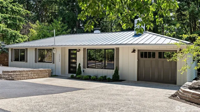 a front view of a house with a garden and porch