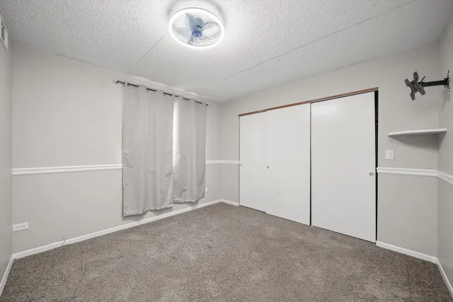 an empty room with a empty space and windows