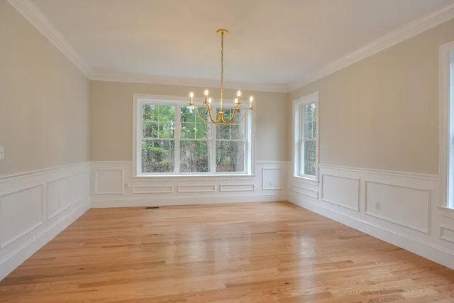 a large kitchen with granite countertop a large counter top a sink stainless steel appliances and cabinets