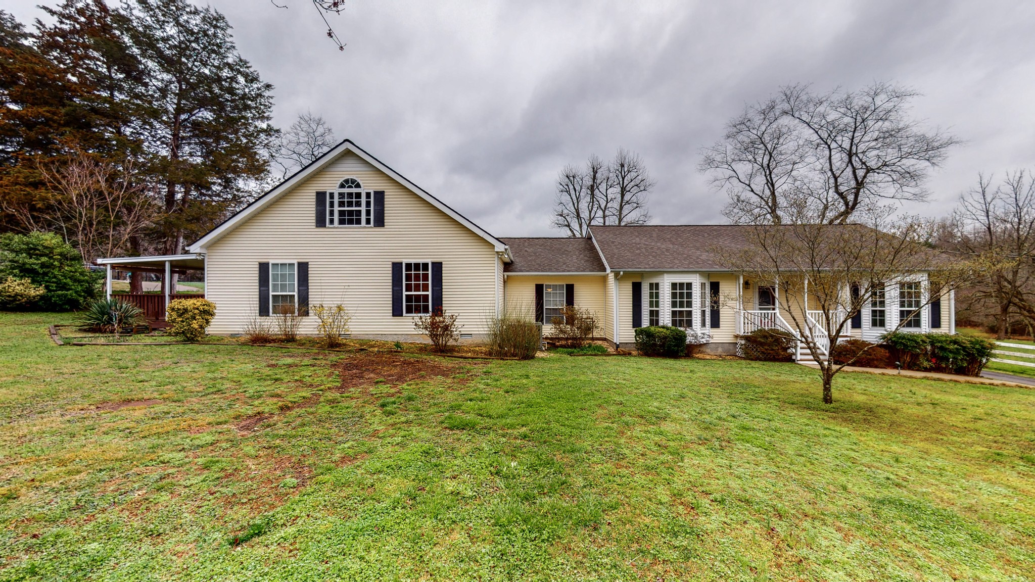 199 Spicer Road Burns, TN 37029 - Photo 1 of 34 a front view of a house with garden