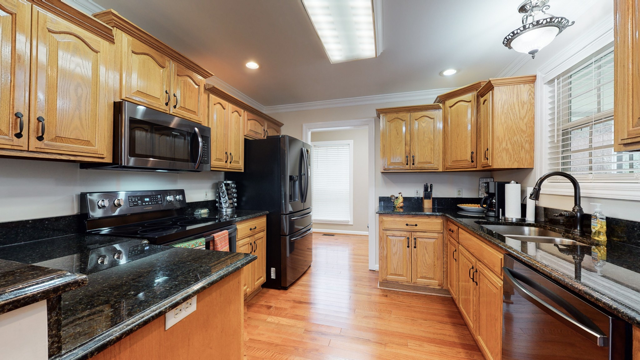 199 Spicer Road Burns, TN 37029 - Photo 19 of 34 a kitchen with stainless steel appliances granite countertop a stove sink microwave and cabinets