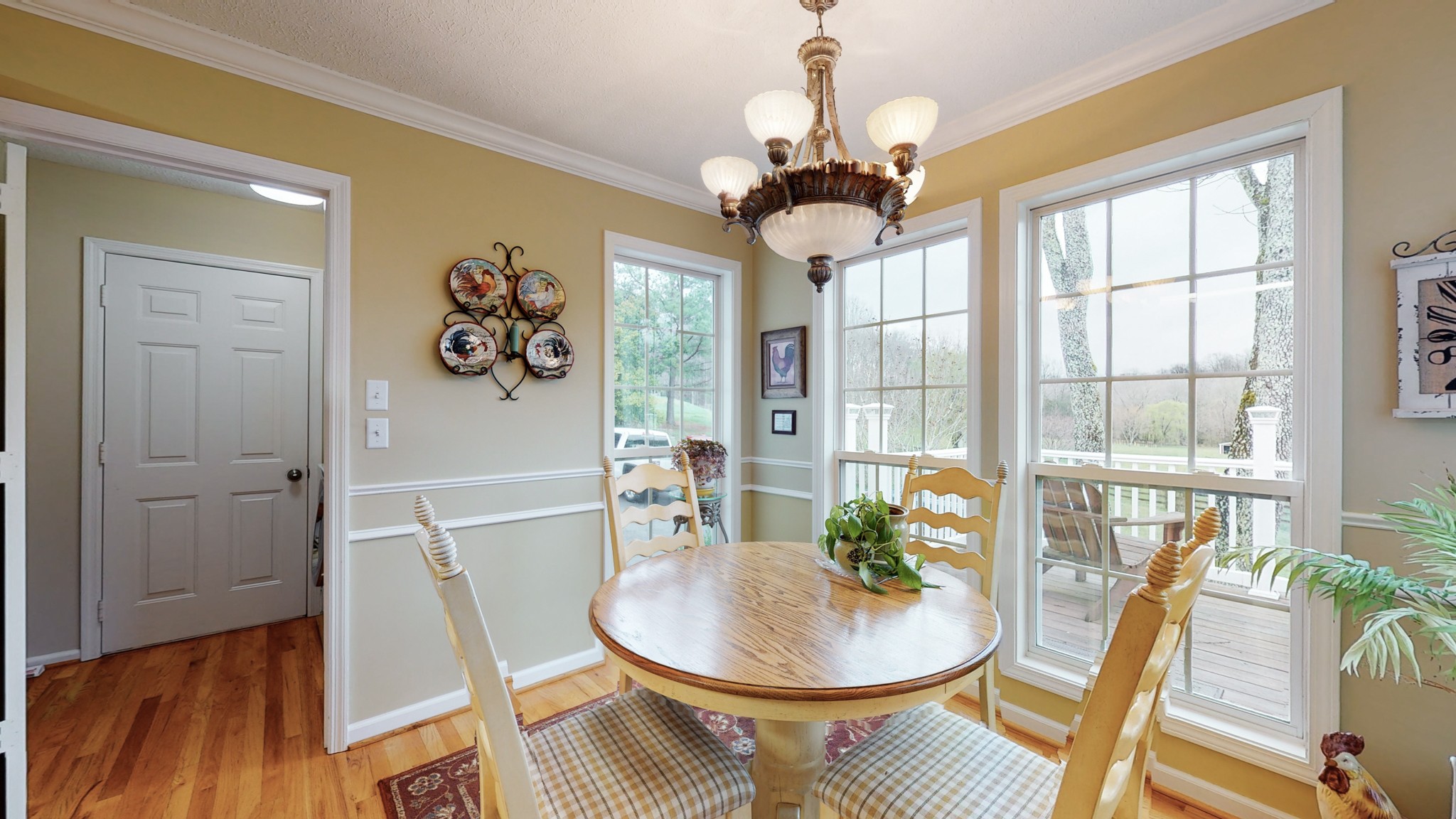 199 Spicer Road Burns, TN 37029 - Photo 25 of 34 a view of a dining room with furniture wooden floor and chandelier