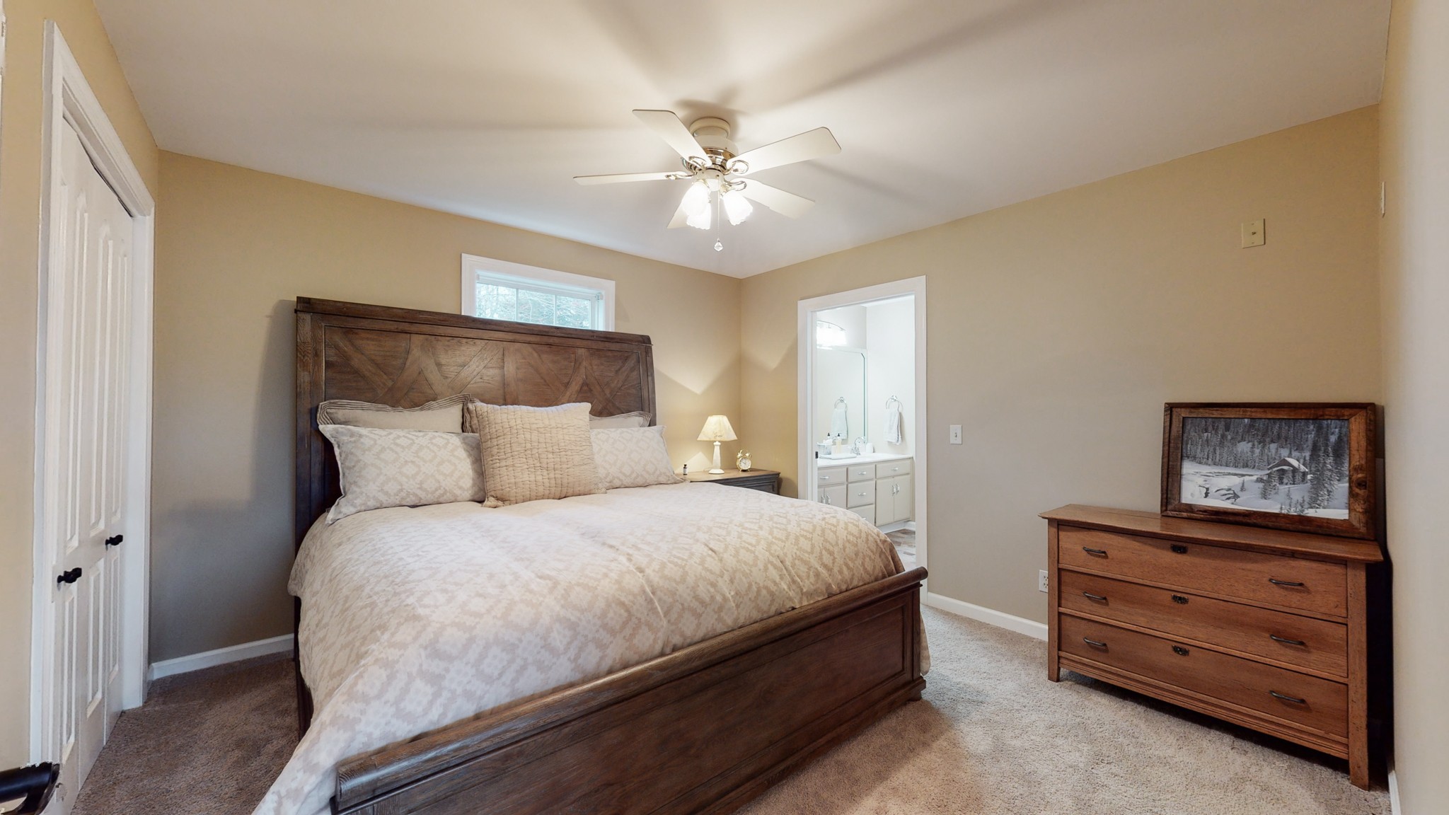 199 Spicer Road Burns, TN 37029 - Photo 30 of 34 a bedroom with a bed and a chandelier