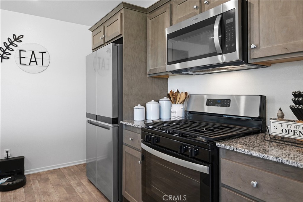 28395 Matador Road Winchester, CA 92596 - Photo 16 of 56 a kitchen with stainless steel appliances granite countertop a stove and a microwave