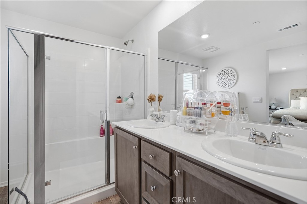 28395 Matador Road Winchester, CA 92596 - Photo 27 of 56 a bathroom with a sink a mirror and a shower