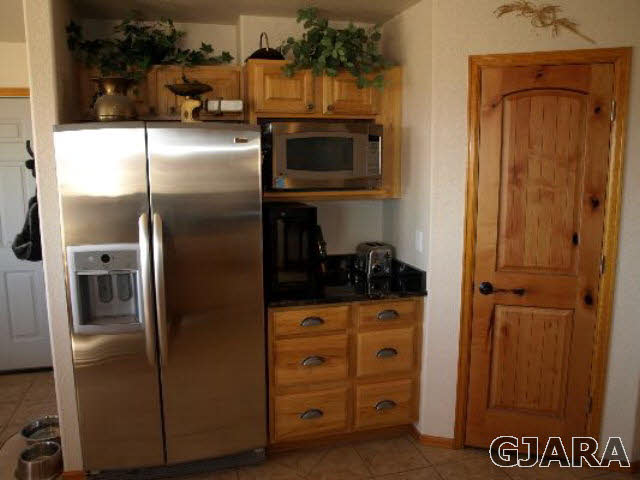 1638 18 Road Fruita, CO 81521 - Photo 7 of 17 a kitchen with stainless steel appliances granite countertop a refrigerator and a stove