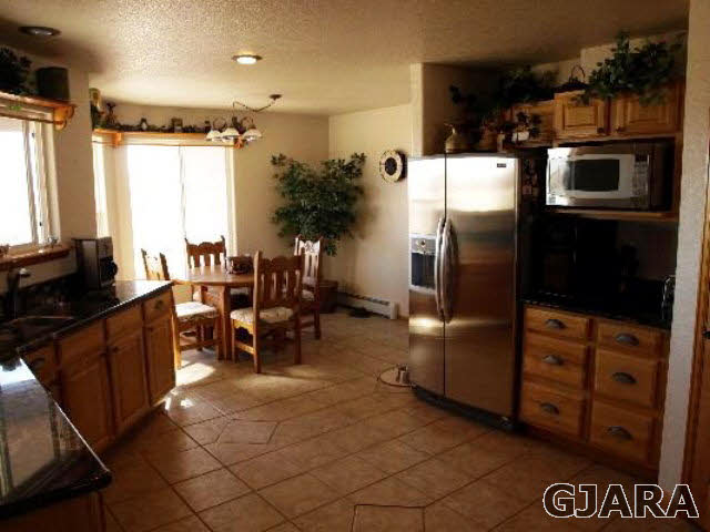 1638 18 Road Fruita, CO 81521 - Photo 8 of 17 a kitchen with refrigerator and chairs