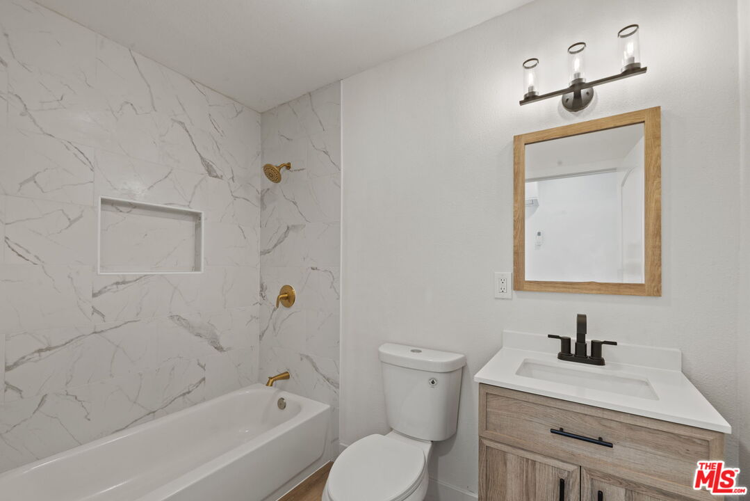 1454 Ricardo Street Los Angeles, CA 90033 - Photo 12 of 27 a bathroom with a bathtub sink vanity mirror and toilet