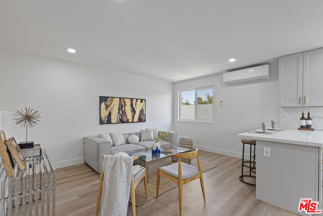 1454 Ricardo Street Los Angeles, CA 90033 - Photo 14 of 27 a workspace with furniture and wooden floor