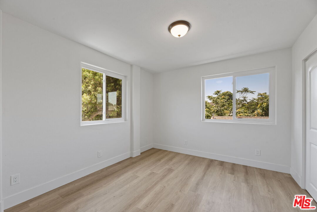 1454 Ricardo Street Los Angeles, CA 90033 - Photo 20 of 27 an empty room with a window and a ceiling fan
