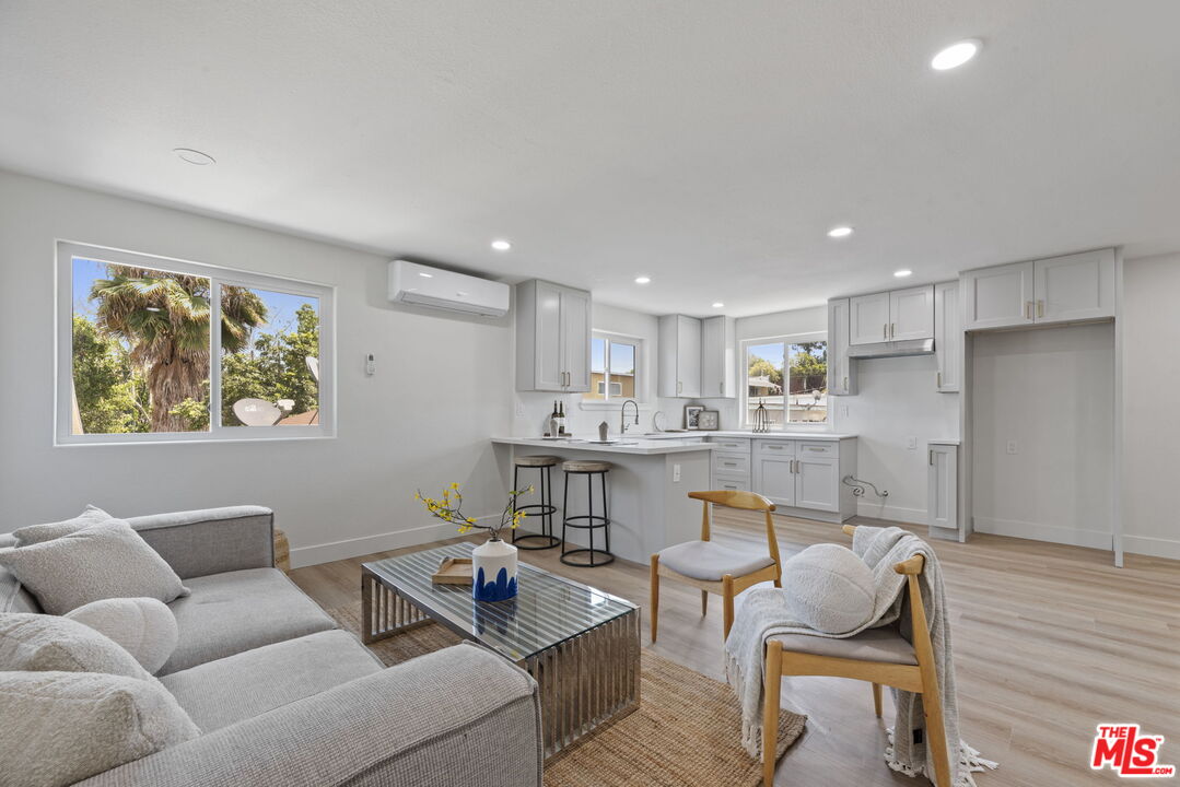 1454 Ricardo Street Los Angeles, CA 90033 - Photo 2 of 27 a living room with stainless steel appliances kitchen island granite countertop furniture and a wooden floor