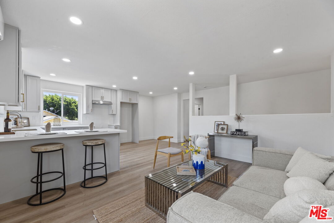 1454 Ricardo Street Los Angeles, CA 90033 - Photo 3 of 27 a living room with furniture kitchen view and a wooden floor