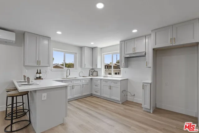 a kitchen with cabinets a sink and appliances in it