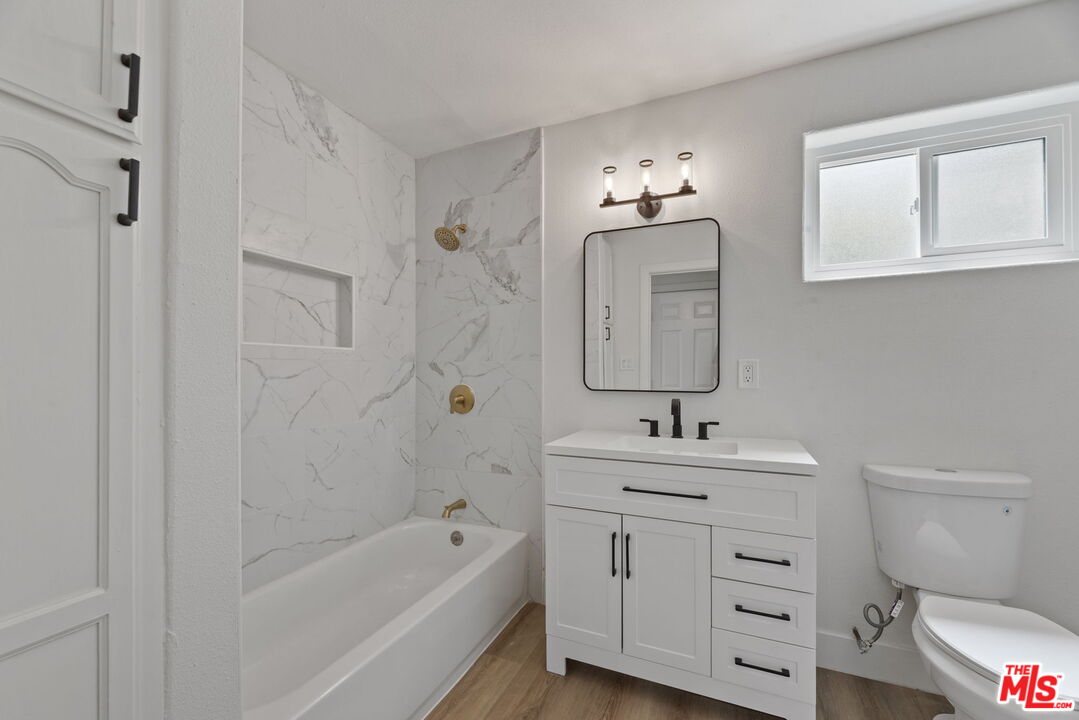 1454 Ricardo Street Los Angeles, CA 90033 - Photo 5 of 27 a bathroom with a sink toilet a tub and shower