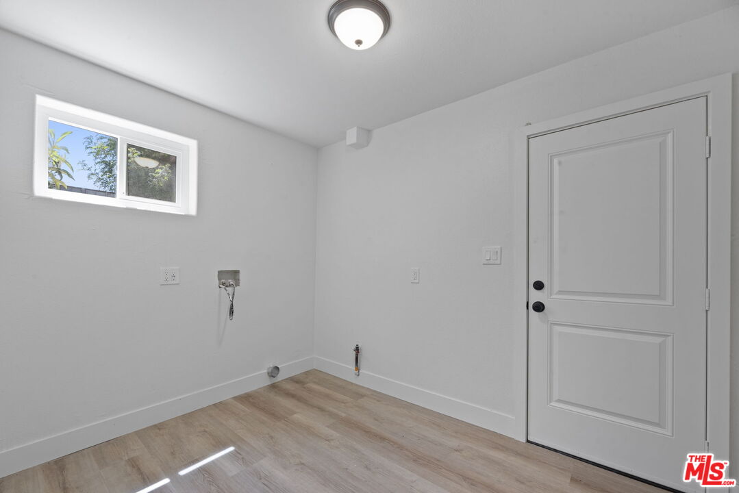 1454 Ricardo Street Los Angeles, CA 90033 - Photo 6 of 27 an empty room with wooden floor and windows