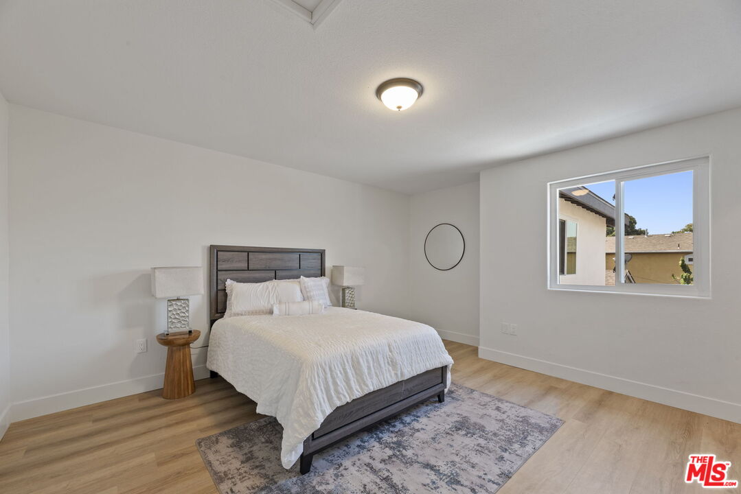 1454 Ricardo Street Los Angeles, CA 90033 - Photo 7 of 27 a bedroom with a bed and painting on the wall