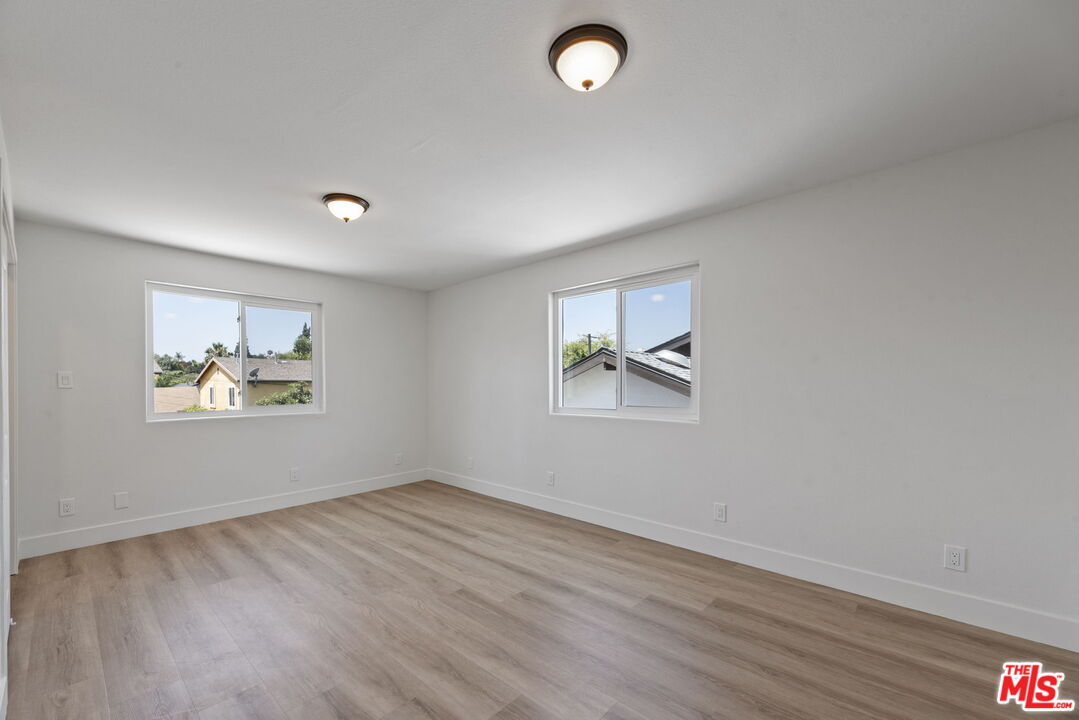 1454 Ricardo Street Los Angeles, CA 90033 - Photo 9 of 27 wooden floor in an empty room with a window