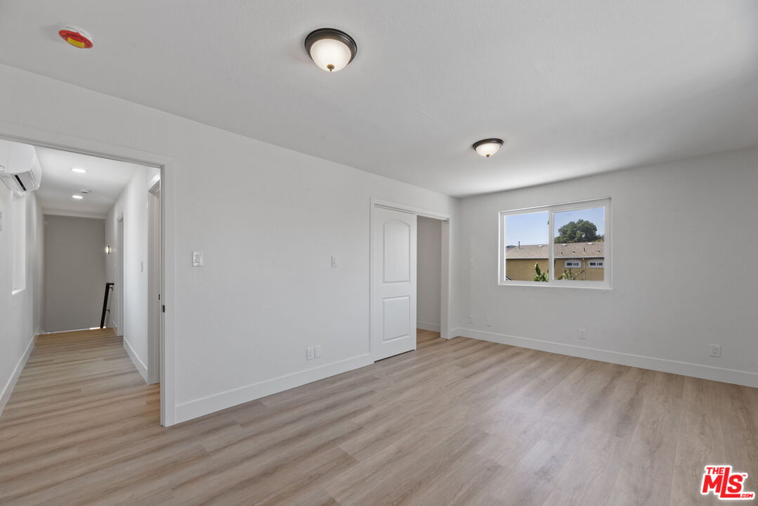1454 Ricardo Street Los Angeles, CA 90033 - Photo 10 of 27 an empty room with wooden floor and windows